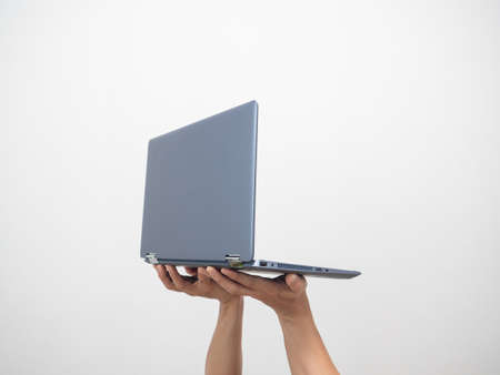 Side view hand holding laptop isolated whiteの写真素材