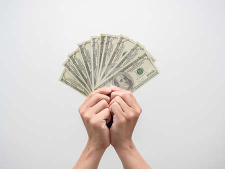 Hand holding a lot of money dollar isolated