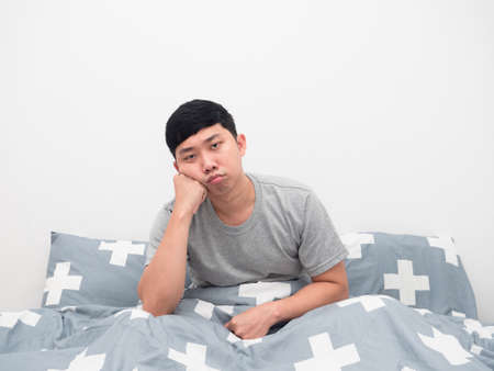 Man sit on the bed gesture bored looking at camera