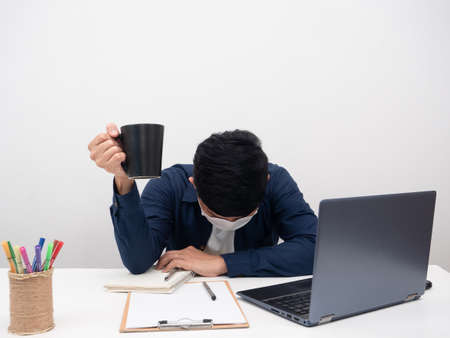 Sickman sitting at workplace feel exhausted and want coffee
