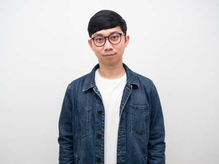 Portrait man jeans shirt wearing glasses looking positive isolatedの写真素材
