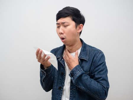Sickness man jeans shirt cough in tissue paper,Portrait asian man coughの写真素材