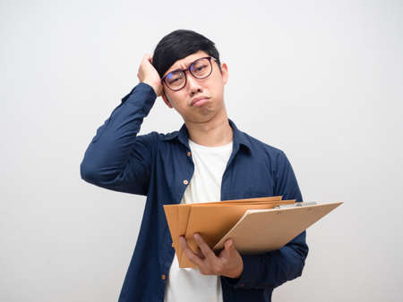 Office worker man disheartened with much work holding document papers,Businessman sadnessの写真素材