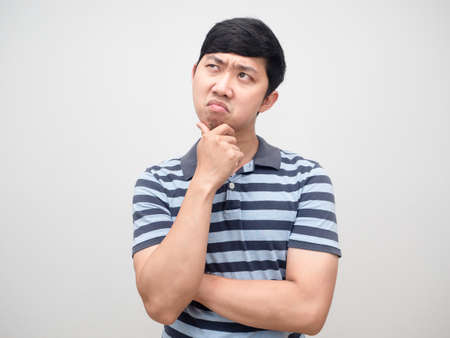 Young man striped shirt serious thinking portraitの写真素材