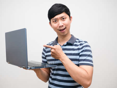 Asian man striped shirt satisfied  with laptop in hand isolatedの写真素材