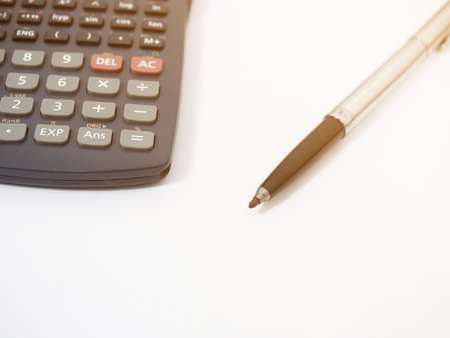Close up pen with calculator isolated whiteの写真素材