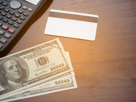 A lot of money and credit card , calculator top view on tableの写真素材
