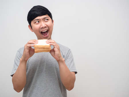 Asian man very hungry eatting sandwich looking at copy space portrait