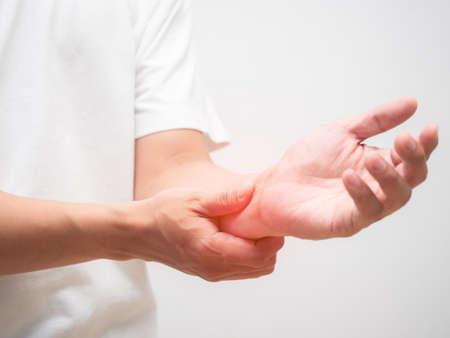 Closeup man hand hurt wrist isolated