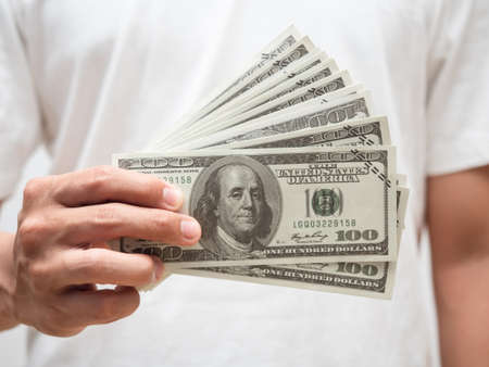 Closeup male hand hodling dollar money