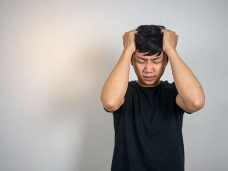 Depressed man hold his face feels strain copy space
