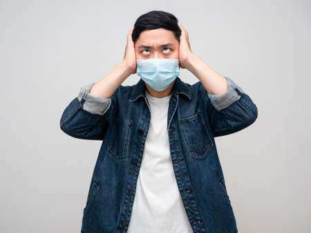 Man jeans shirt wear medical mask headache cross eyes feels doubt