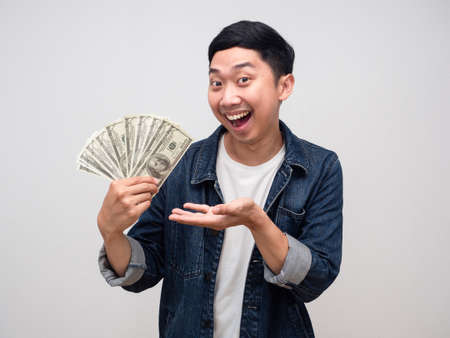 Positive man cheerful smile show a lot of money in his hand isolated