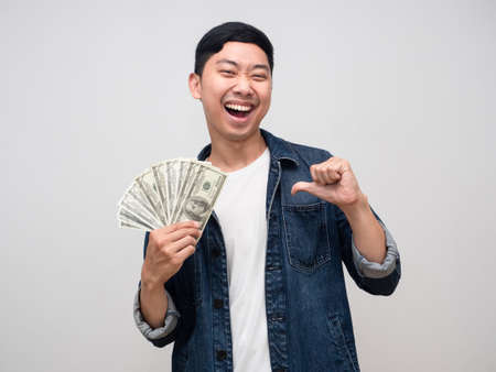 Cheerful man jeans shirt smile and happy about earn money point finger at himself isolatedの写真素材
