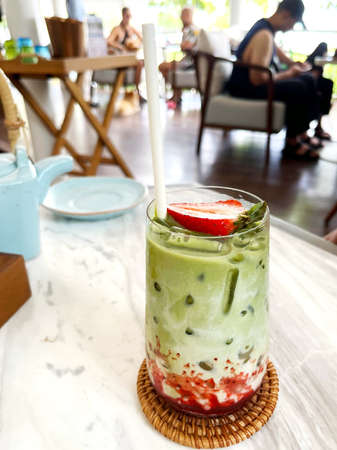 Strawberry matcha tea on the table in cafe fresh drink dessert morningの写真素材