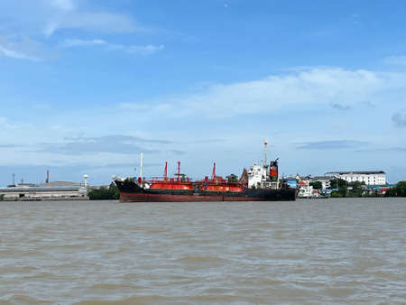 Cargo ship loading in the ocean background with the blue sky and white cloudy landscape,Logistic transportation conceptの写真素材