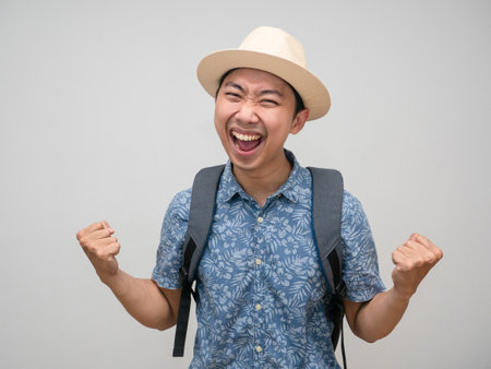 Cheerful traveler man with backpack feels satisfied happyの写真素材