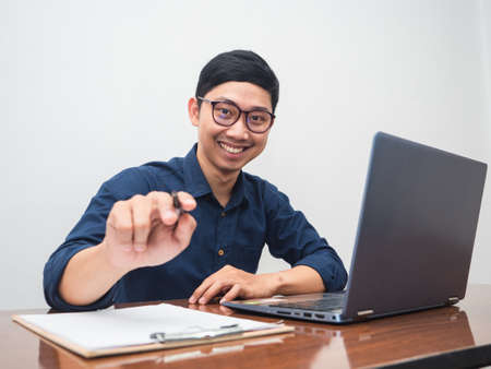Businessman smile and point at you for choosing you about workingの写真素材
