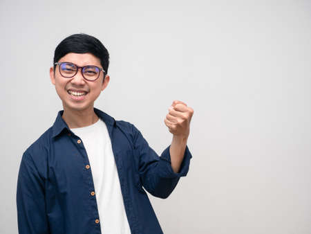 Asian man wear glasses gesture pull rope heavy isolatedの写真素材