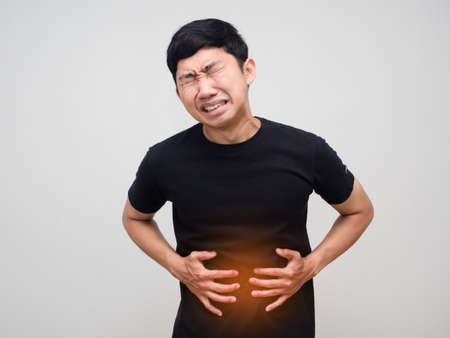 Asian man hold his belly feels very stomach ache isolatedの写真素材