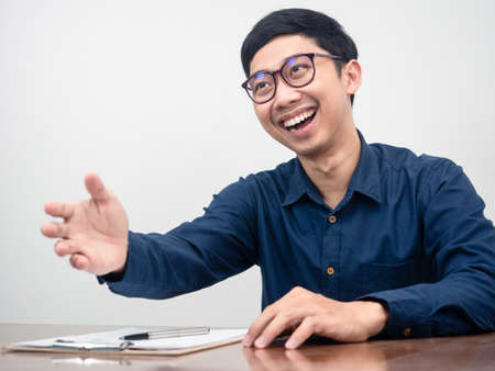 Positive man wear glasses gesture shake hand happy smile about interviewの写真素材