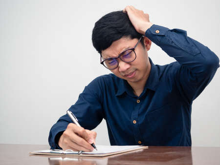 Young businessman serious and headache with testing on tableの写真素材