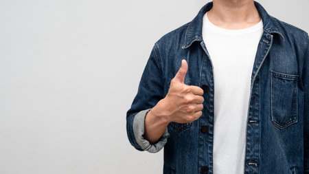 Close up man jeans shirt with watch show thumb up isolatedの写真素材