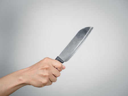Close up hand holding silver knief,Killer hand holding knief isolatedの写真素材