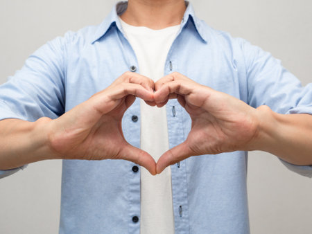 Close up man make hands heart for lover studio shot portraitの写真素材