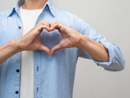 Close up man make hands heart for lover studio shot portraitの写真素材