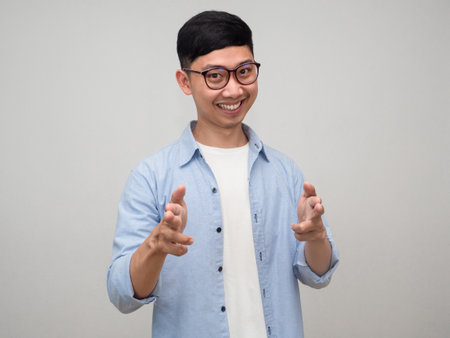 Young businessman wear glasses cheerful gesture point finger at you isolatedの写真素材