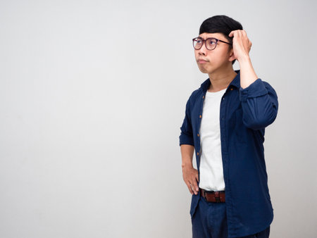 Asian businessman feels confused scratch his head isolatedの写真素材