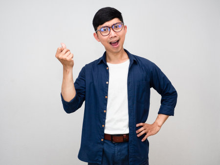 Positive asian businessman gesture snap finger get idea for business isolatedの写真素材