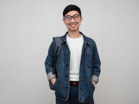 Portrait man jeans shirt wear glasses gentle smile push hands in shirt pocket isolatedの写真素材