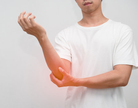 Male employee elbow pain from hard working office syndromeの写真素材