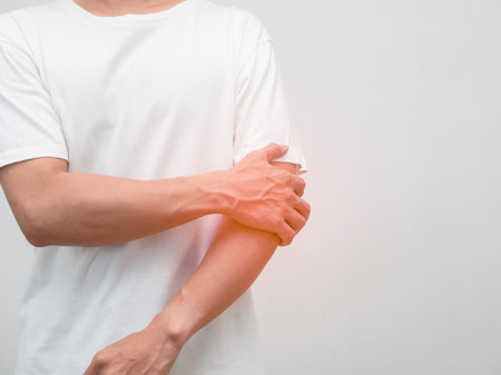 Male employee elbow pain from hard working office syndromeの写真素材