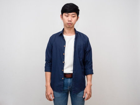 Asian man standing feels hopeless and disheartened isolatedの写真素材