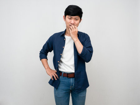 Asian man standing feels hopeless and disheartened isolatedの写真素材