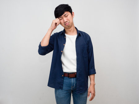 Asian man standing feels lonely and depressed gesture cry isolatedの写真素材