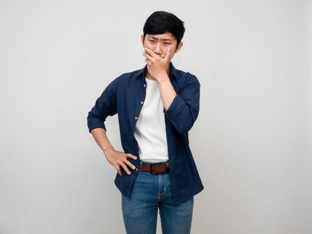 Sadness asian man standing cry and close his mouth isolatedの写真素材