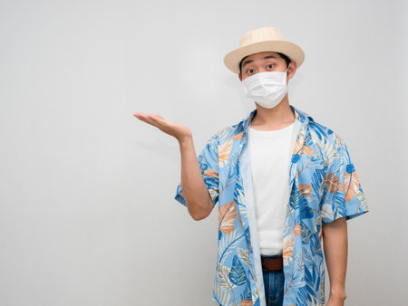 Traveler man wear hat show empty hand up isolatedの写真素材