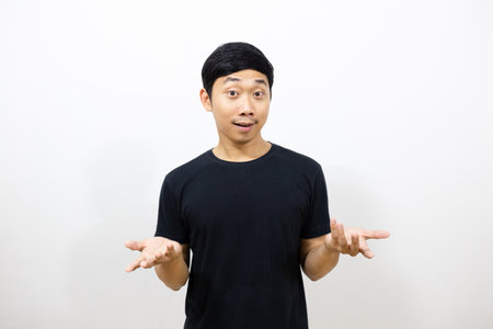 Asian man black shirt showing hand up feels confusedの写真素材