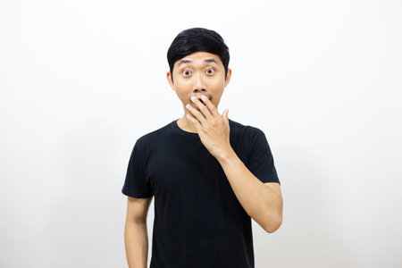 Asian man black shirt excited show hand at his mouth isolatedの写真素材