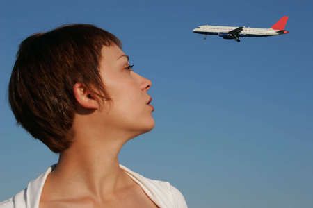 Portrait of a woman looking at a transport aircraftの写真素材