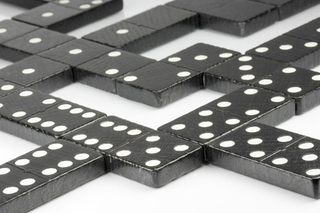 Composition of lying black domino bricks with white dots