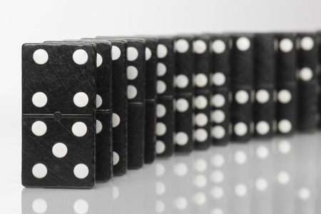 Composition of standing black domino bricks with white dots