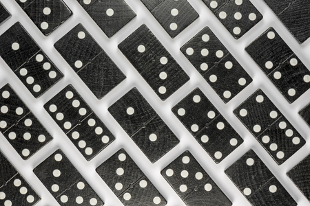 Composition of lying black domino bricks with white dotsの写真素材