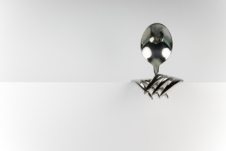 Metal spoon and two forks formed into conceptual fantasy figure
