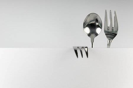 Metal spoon and two forks formed into conceptual fantasy figureの写真素材