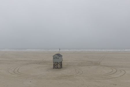 The sea cottage of Terschelling is from the end of 2015 posted near pole 24 on the North Sea Beach at the dunes on a larger and more secure distance from the North Sea kelingenhuisje Brooke-Terschelling on new location. Picture was taken on a foggy and drの写真素材